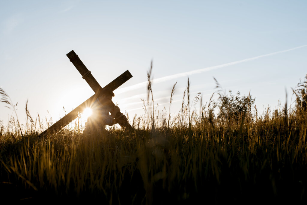man carrying cross